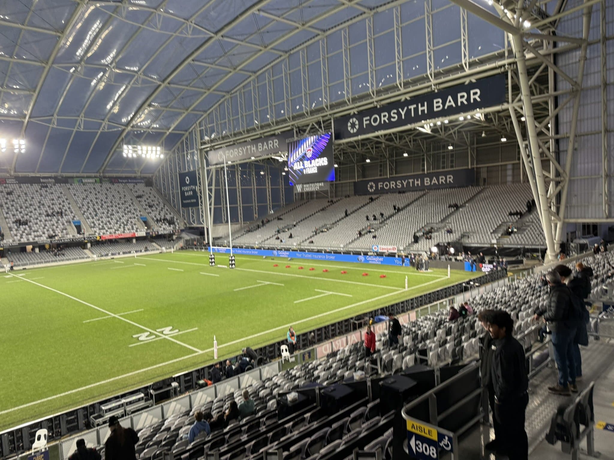 Inside Forsyth Barr Stadium in Dunedin, looking over the green rugby pitch under the covered roof